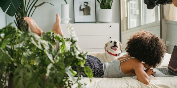 woman with dog on bed