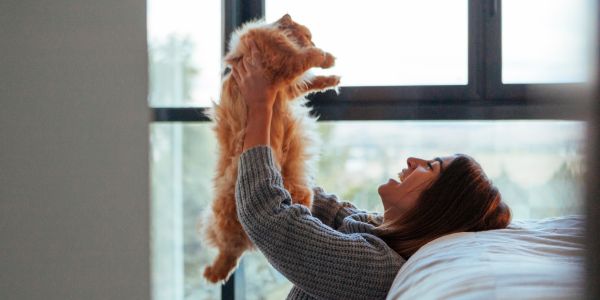 Young female play with her cat in an urban area