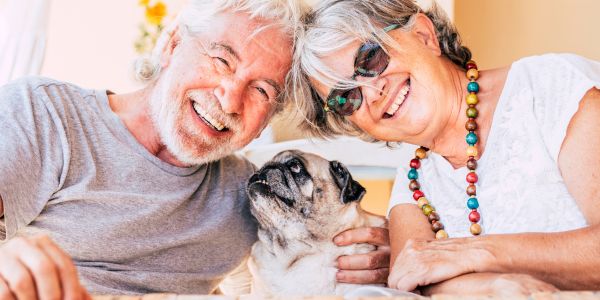 an older couple with their senior dog