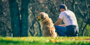 man and his dog sitting outside